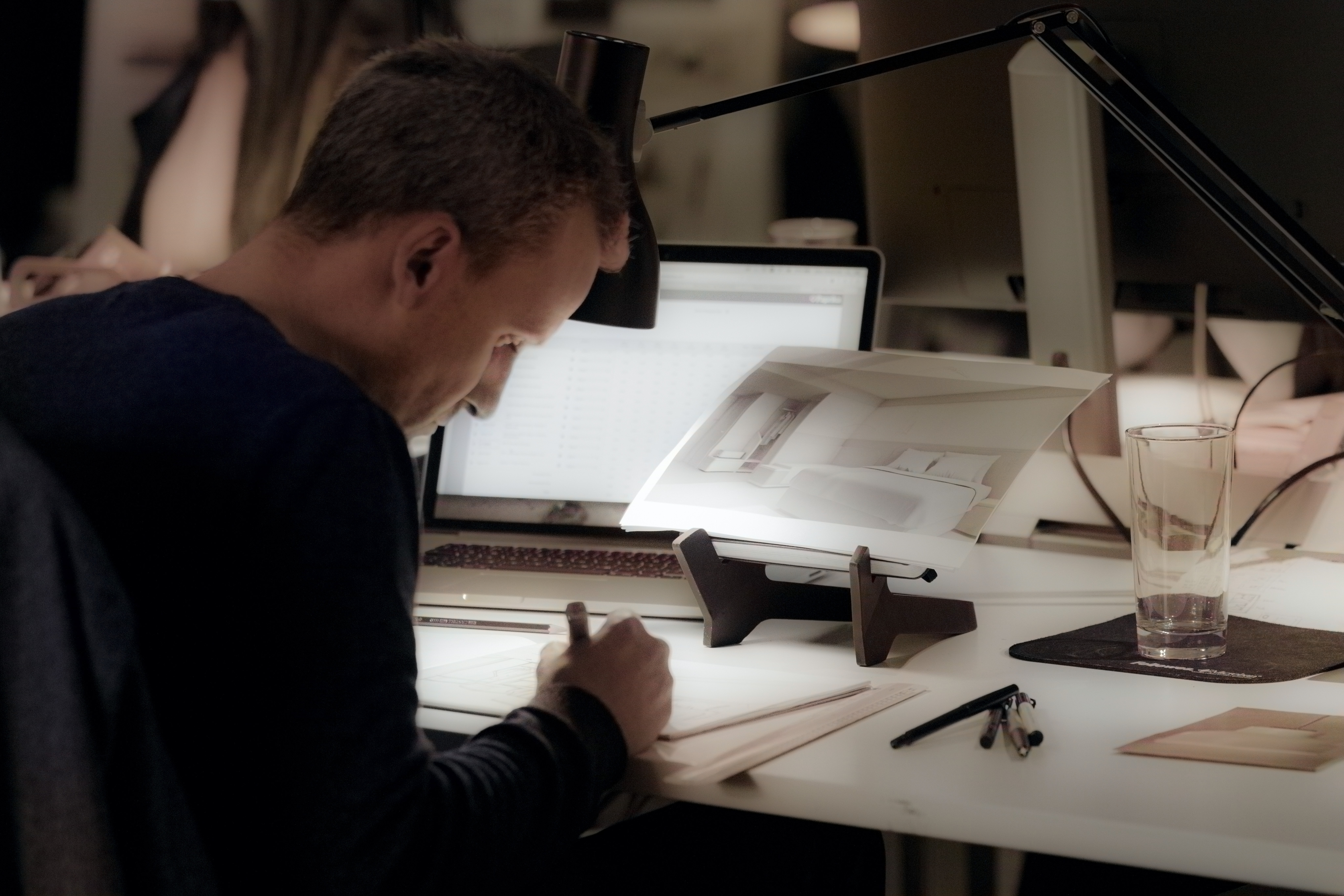 Designer sketching at a studio desk